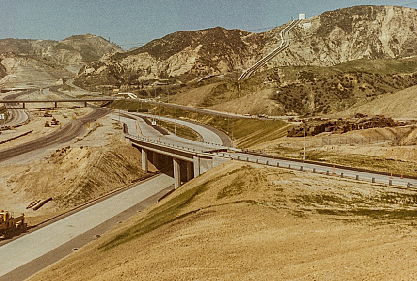 The I-5 / Hiway 14 interchange was still in the final stages of construction when the earthquake hit. This image is deceptive as most of the damage was at the top of the frame. However the roadway that leads in from the lower right is split just after the overpass (detail in another image). 